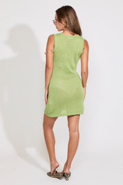 Model is wearing a green semi sheer sleeveless knit swim cover up over a white bikini set on a white background.