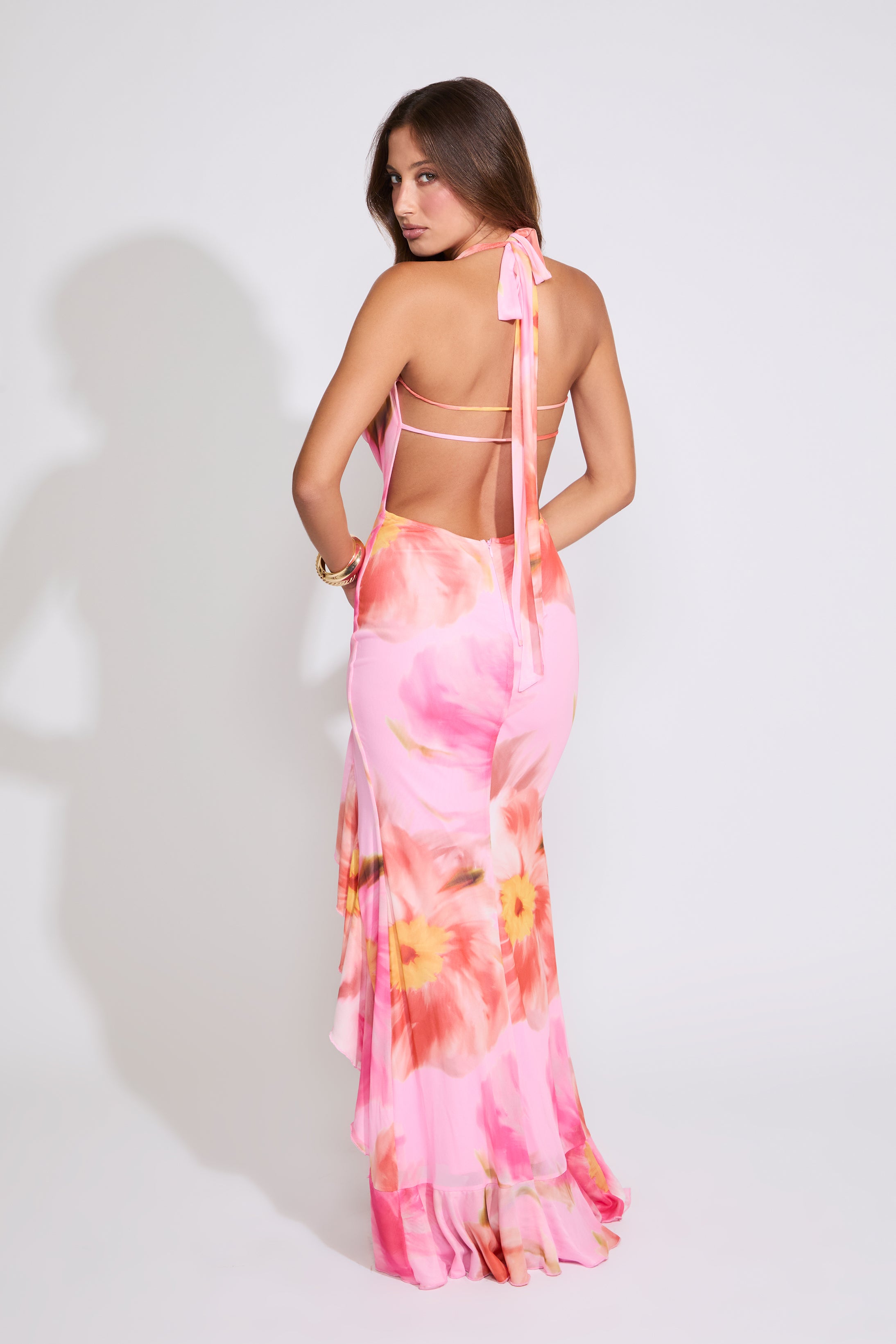 Model is wearing a pink FLORAL TIE COWL NECK MAXI DRESS WITH RUFFLE SLIT on a white background.