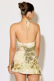 Woman wearing a floral dress against a plain background