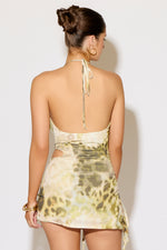 Woman wearing a floral dress against a plain background
