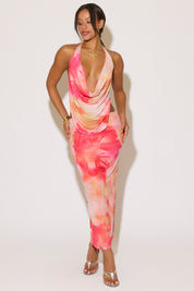 Woman wearing a colorful tie-dye dress on a white background