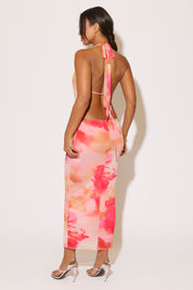 Woman wearing a colorful floral dress with a white background