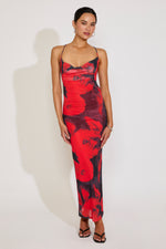 Woman wearing a red and black floral dress on a white background