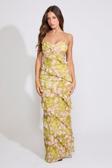 Model is wearing a sage RUFFLED ROSE PRINT CROSS BACK MAXI DRESS on a white background.