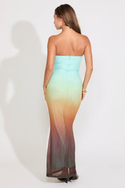 Model is wearing a strapless mermaid maxi dress on a white background.