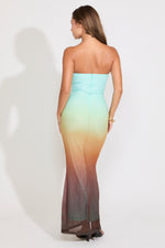 Model is wearing a strapless mermaid maxi dress on a white background.