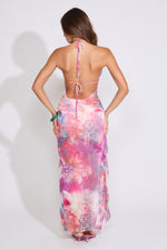 Model is wearing a pink FLORAL RUFFLE BEADED BACKLESS MAXI DRESS with pink heels on a white background.