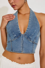 Denim halter top worn by a person on a plain background