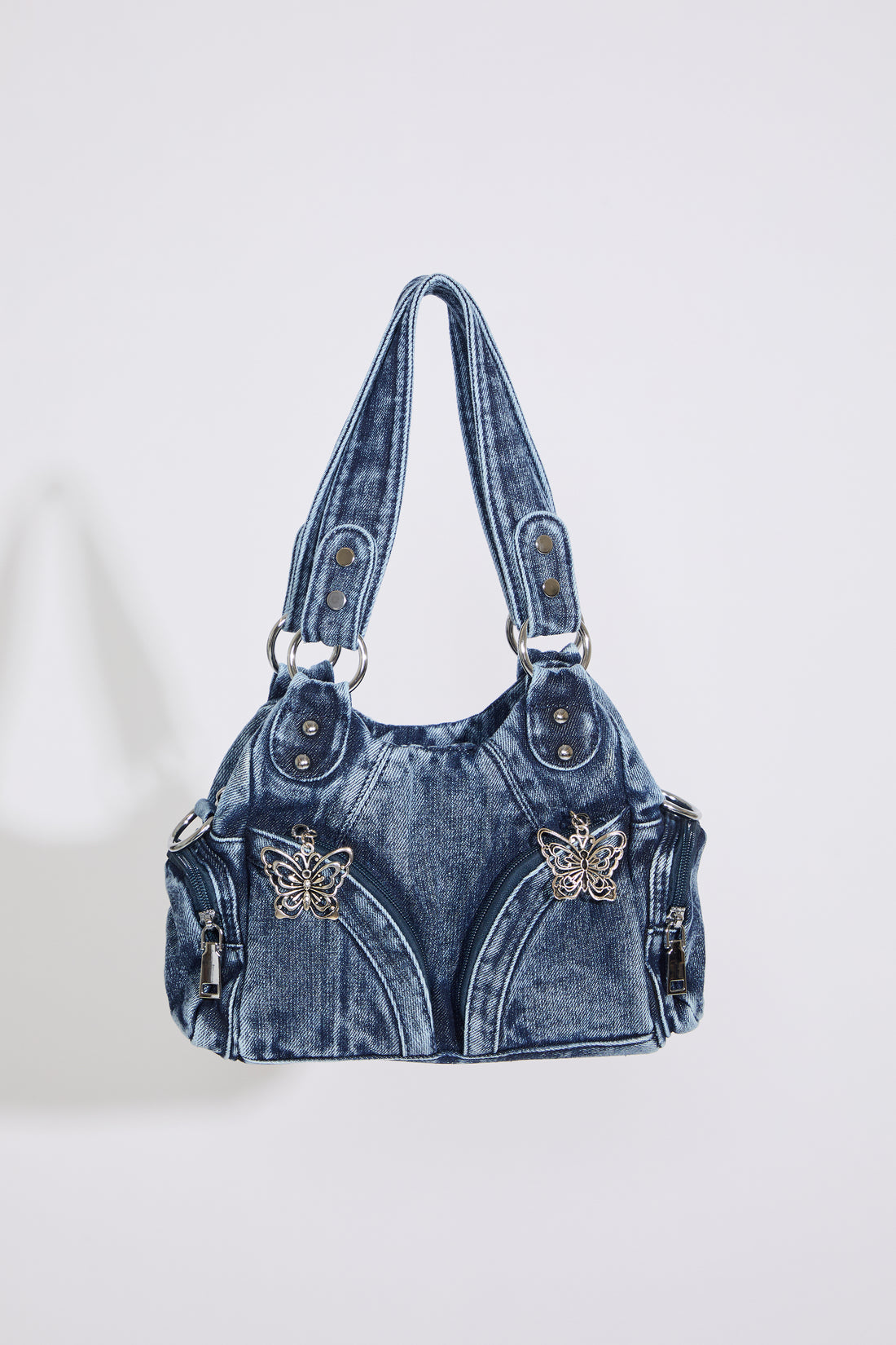 MEDIUM DENIM HOBO STYLE BAG W BUTTERFLY DTL on a white background.