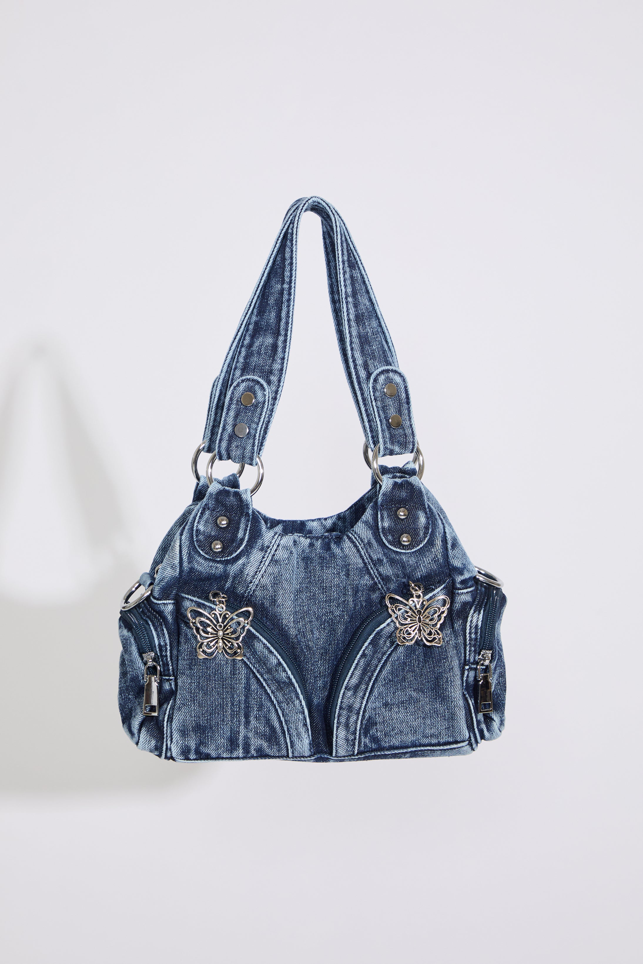 MEDIUM DENIM HOBO STYLE BAG W BUTTERFLY DTL on a white background.