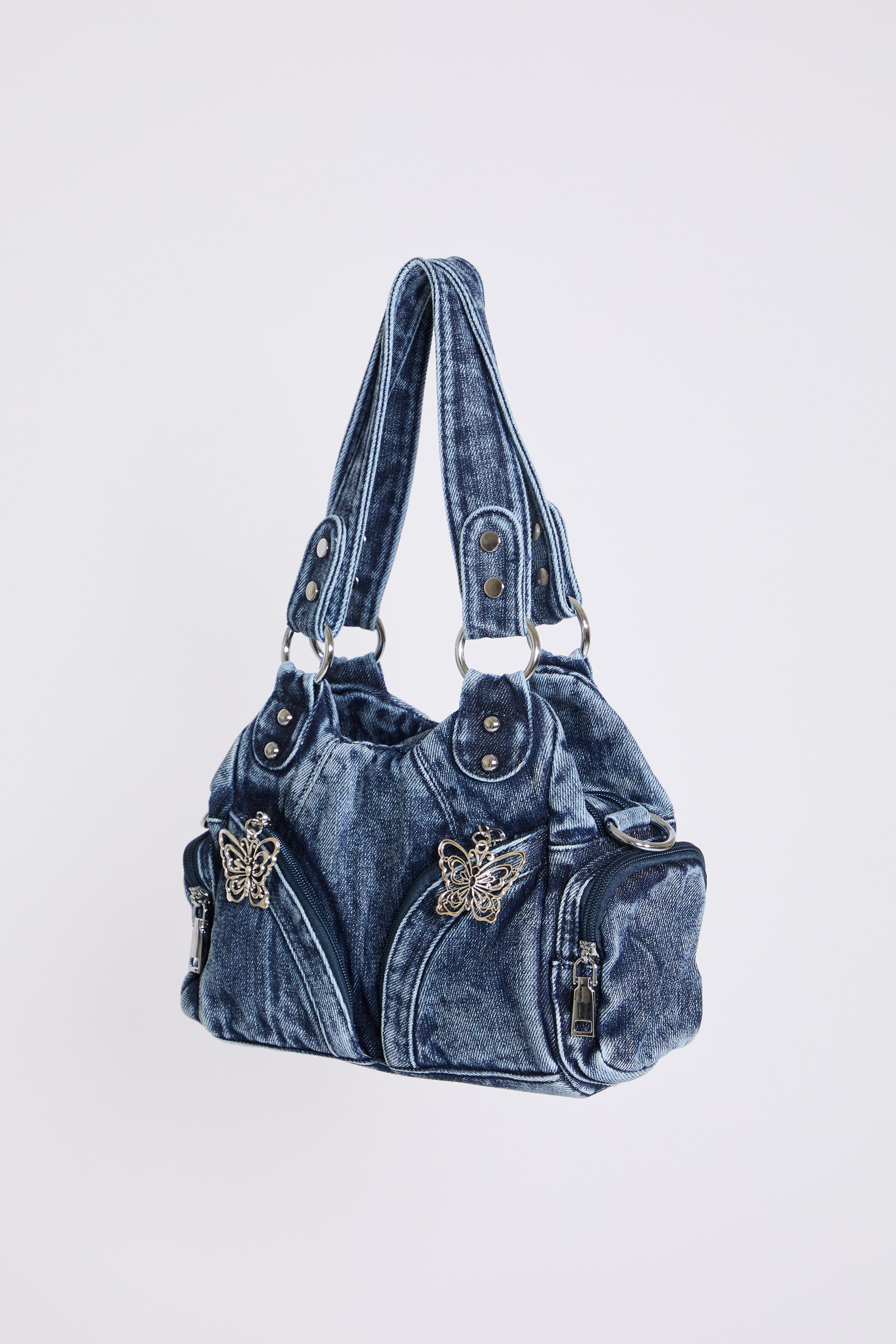 MEDIUM DENIM HOBO STYLE BAG W BUTTERFLY DTL on a white background.