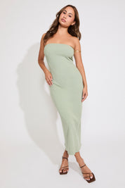 Model is wearing a sage acid washed ribbed midi tube dress on a white background.