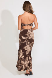 Model is wearing a strapless brown floral print maxi dress on a white background.