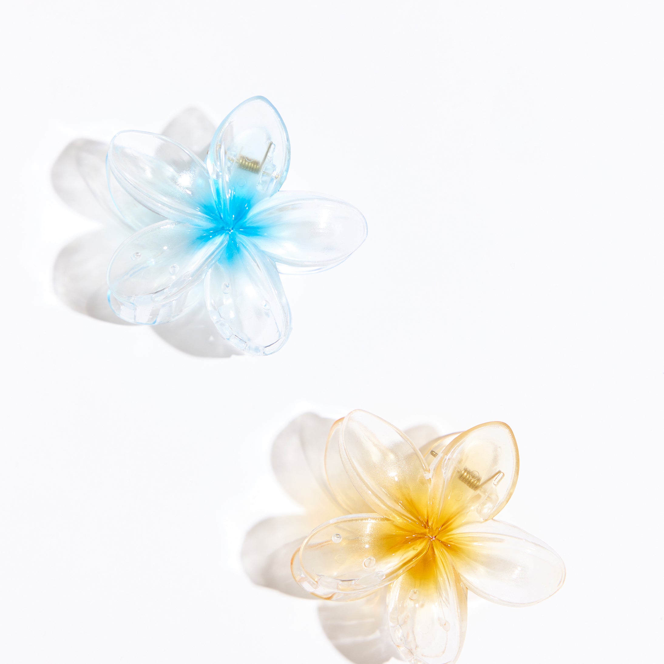Two plastic hair clips on a white background. 