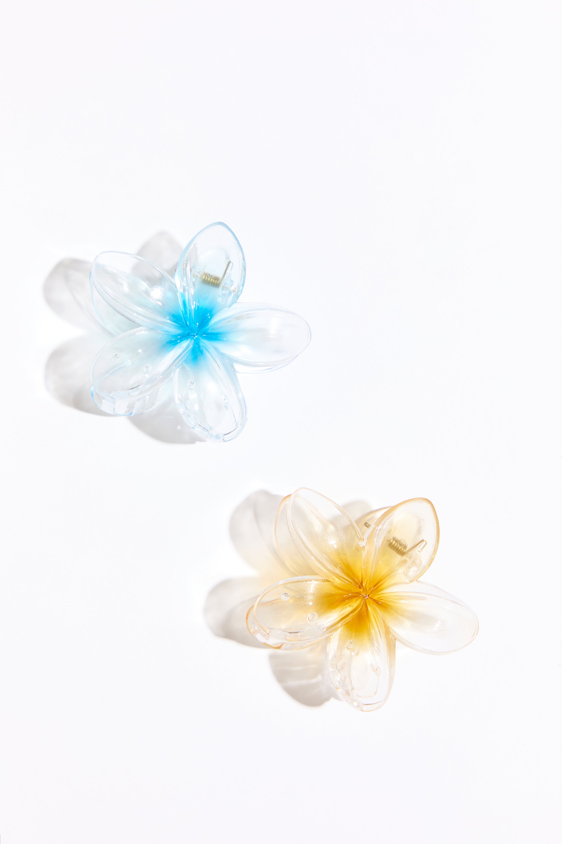 Two plastic hair clips on a white background. 