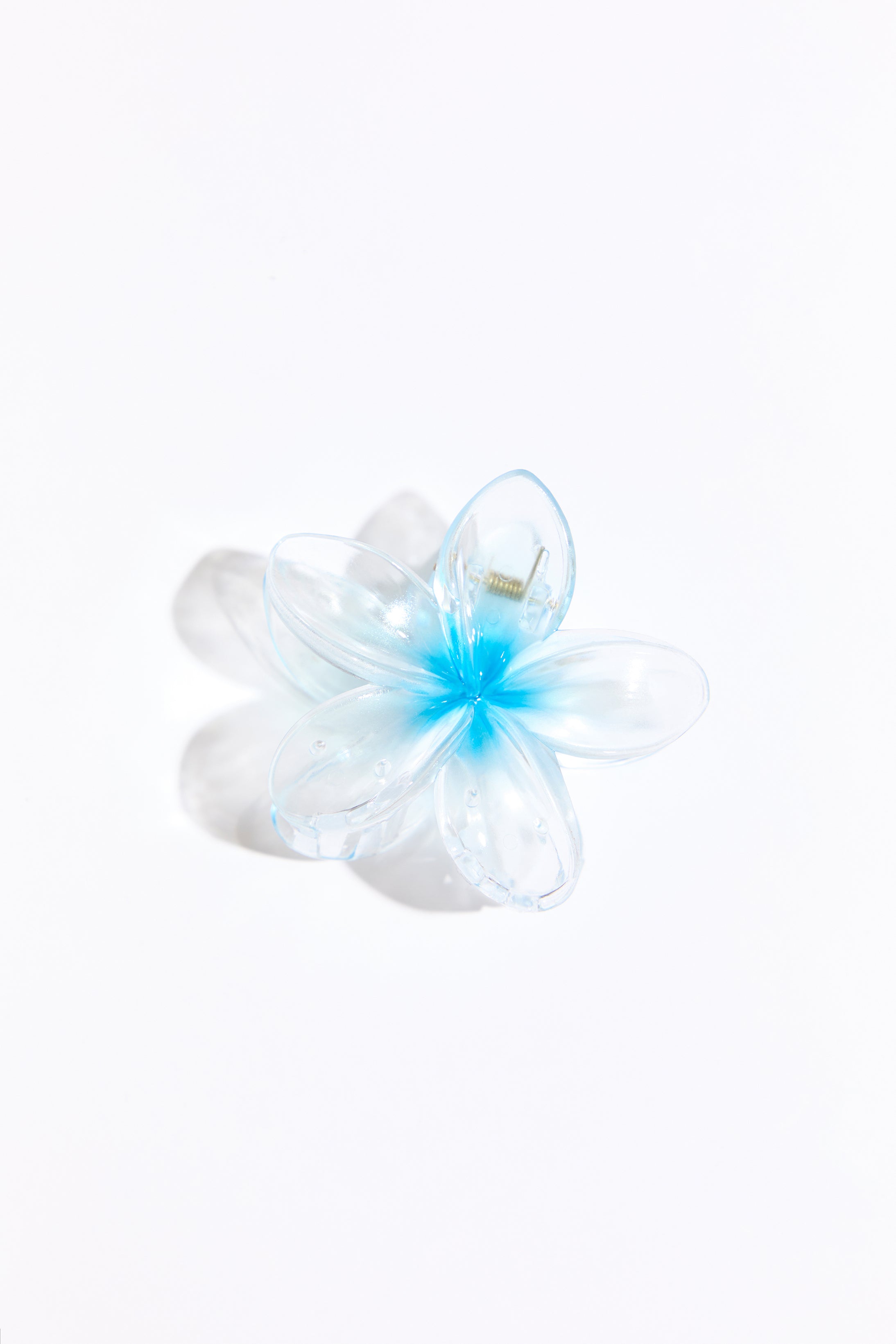 Blue plastic hair clip on a white background.