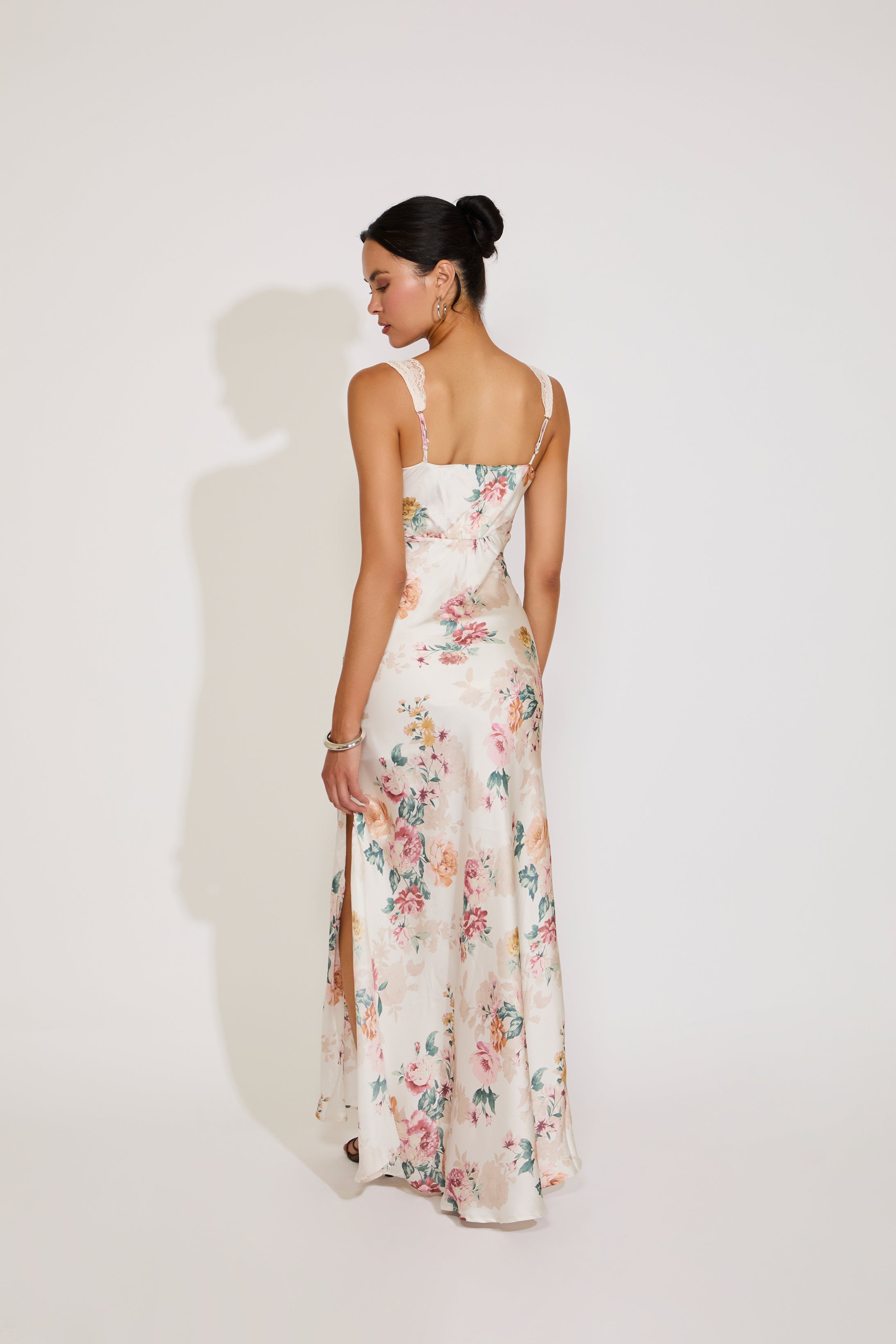 Woman wearing a floral dress against a white background