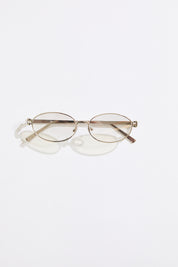 Gold rimmed glasses with silver  lenses on a  white background
