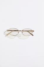 Gold rimmed glasses with silver  lenses on a  white background
