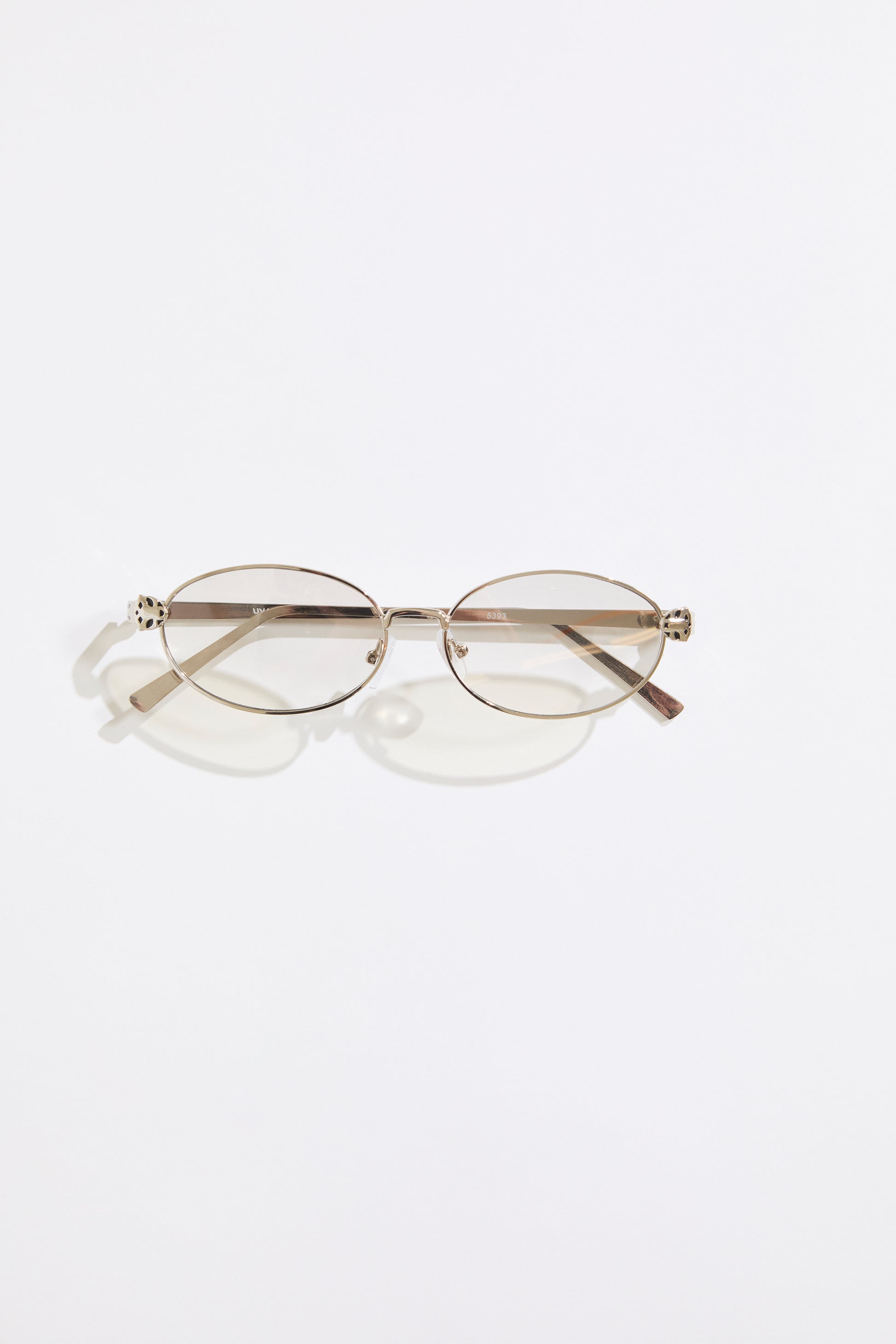 Gold rimmed glasses with silver  lenses on a  white background