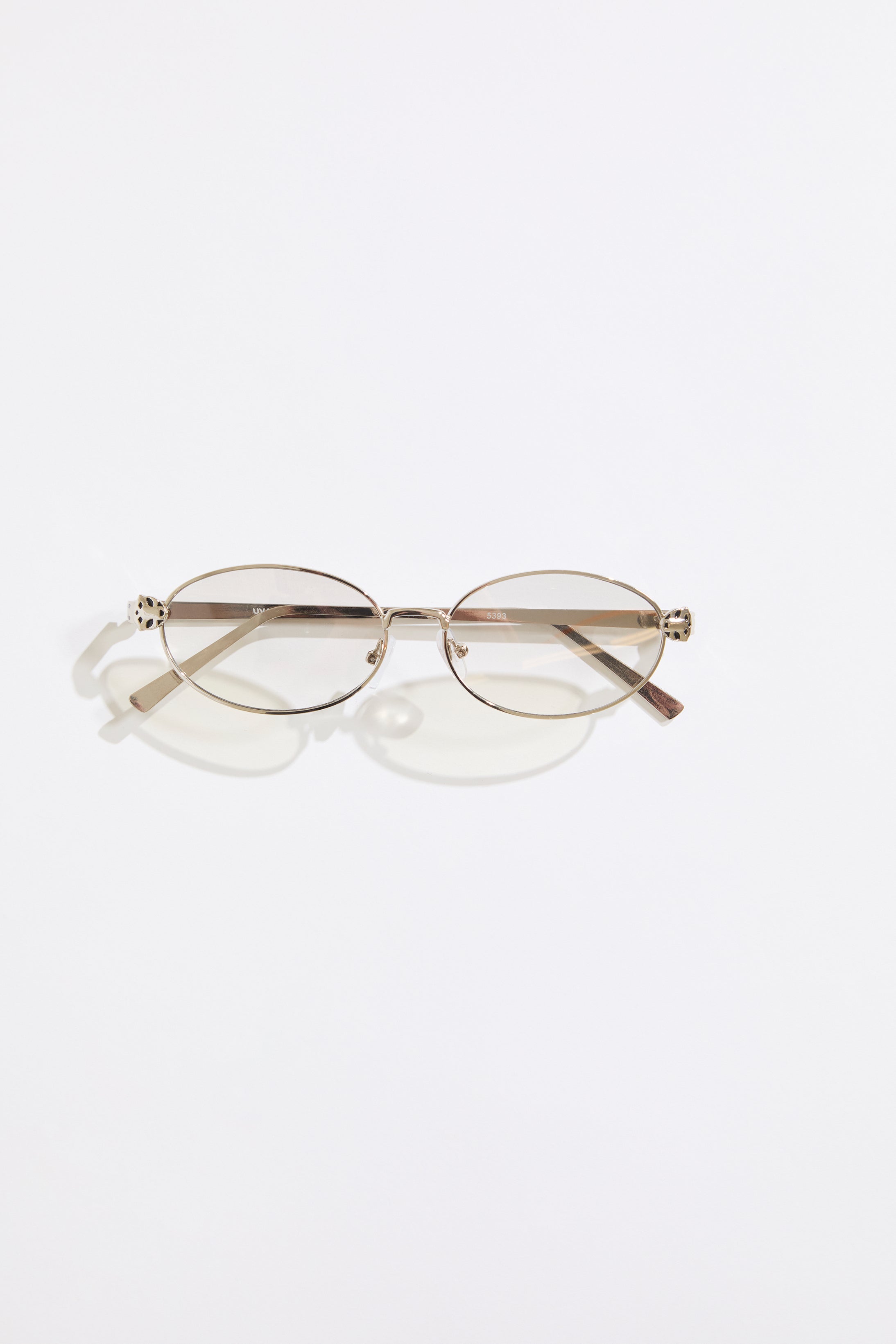 Gold rimmed glasses with silver  lenses on a  white background