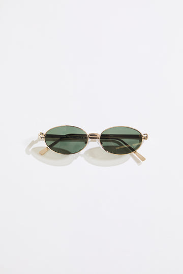 Gold rimmed glasses with olive lenses on a  white background