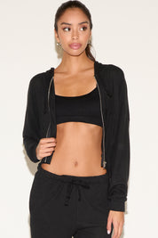 Woman wearing a black athletic outfit on a white background