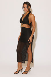 Woman wearing a black dress with mesh panels on a white background