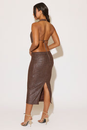 Woman wearing a sparkly brown dress with a white background