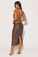 Woman wearing a sparkly brown dress with a white background