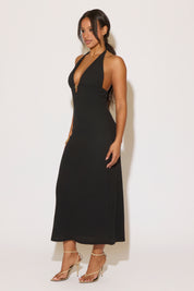 Woman wearing a black dress against a white background