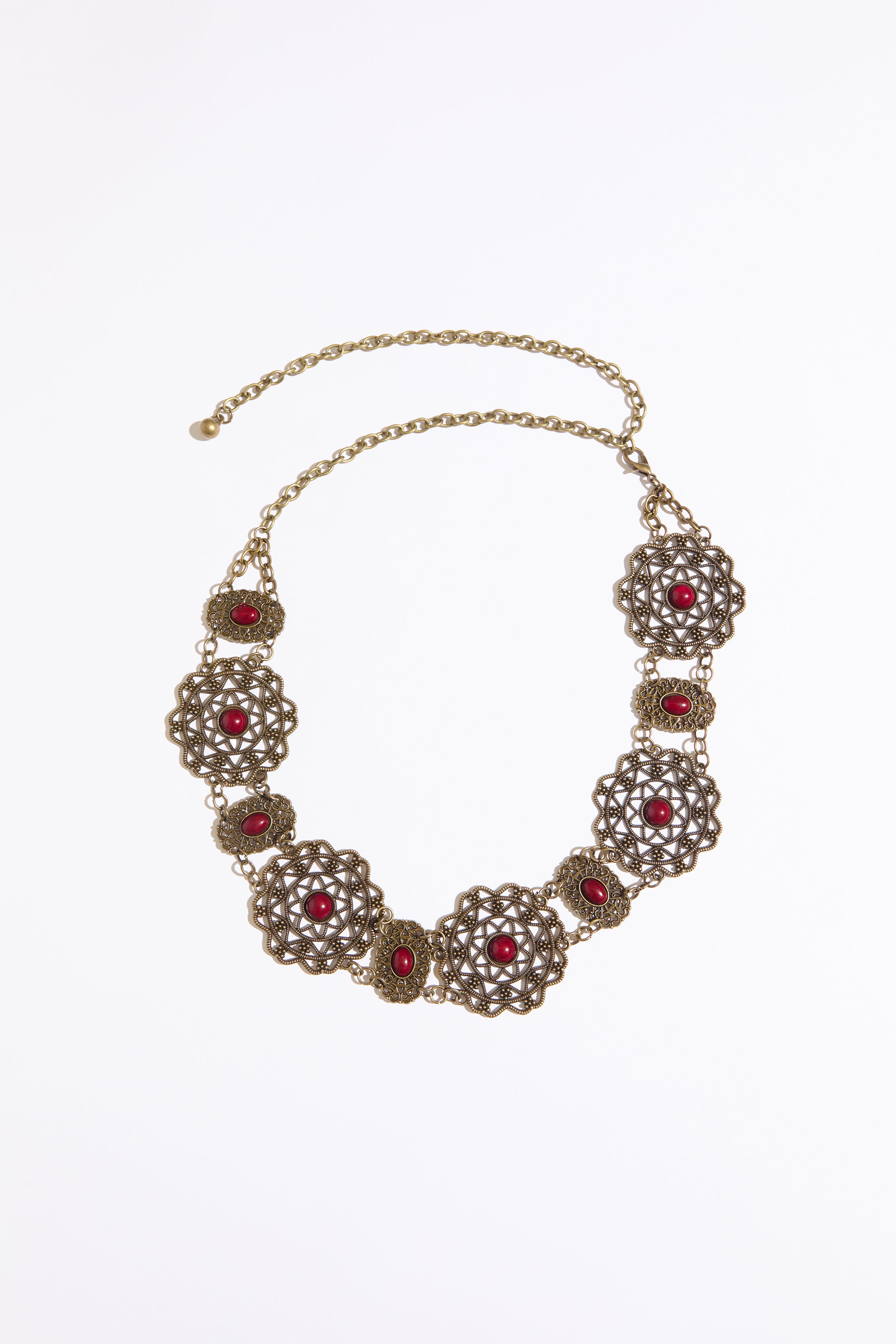 Cab accented filigree chain belt on a white background.