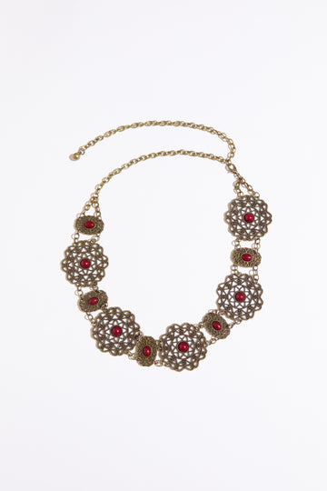 Cab accented filigree chain belt on a white background.