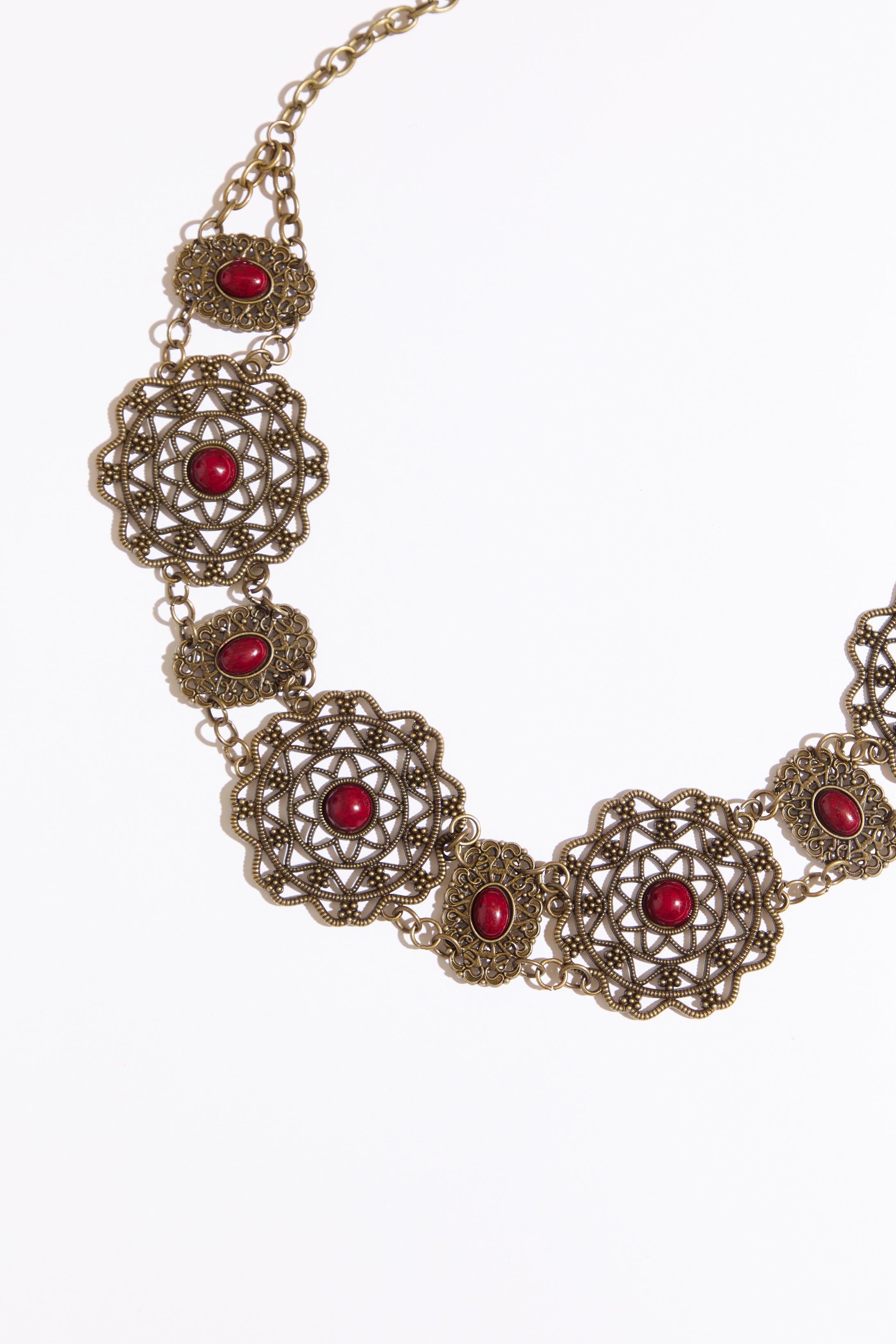 Cab accented filigree chain belt on a white background.