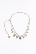 Draped heart charms chain belt on a white background.