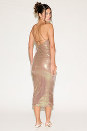 Woman wearing a sparkly dress on a white background