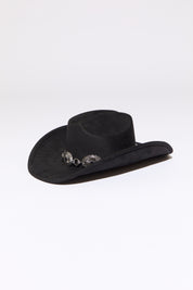 Black cowboy hat with stone accent concho beaded silver  chain on a white background. 