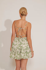 Woman wearing a floral dress with a white background
