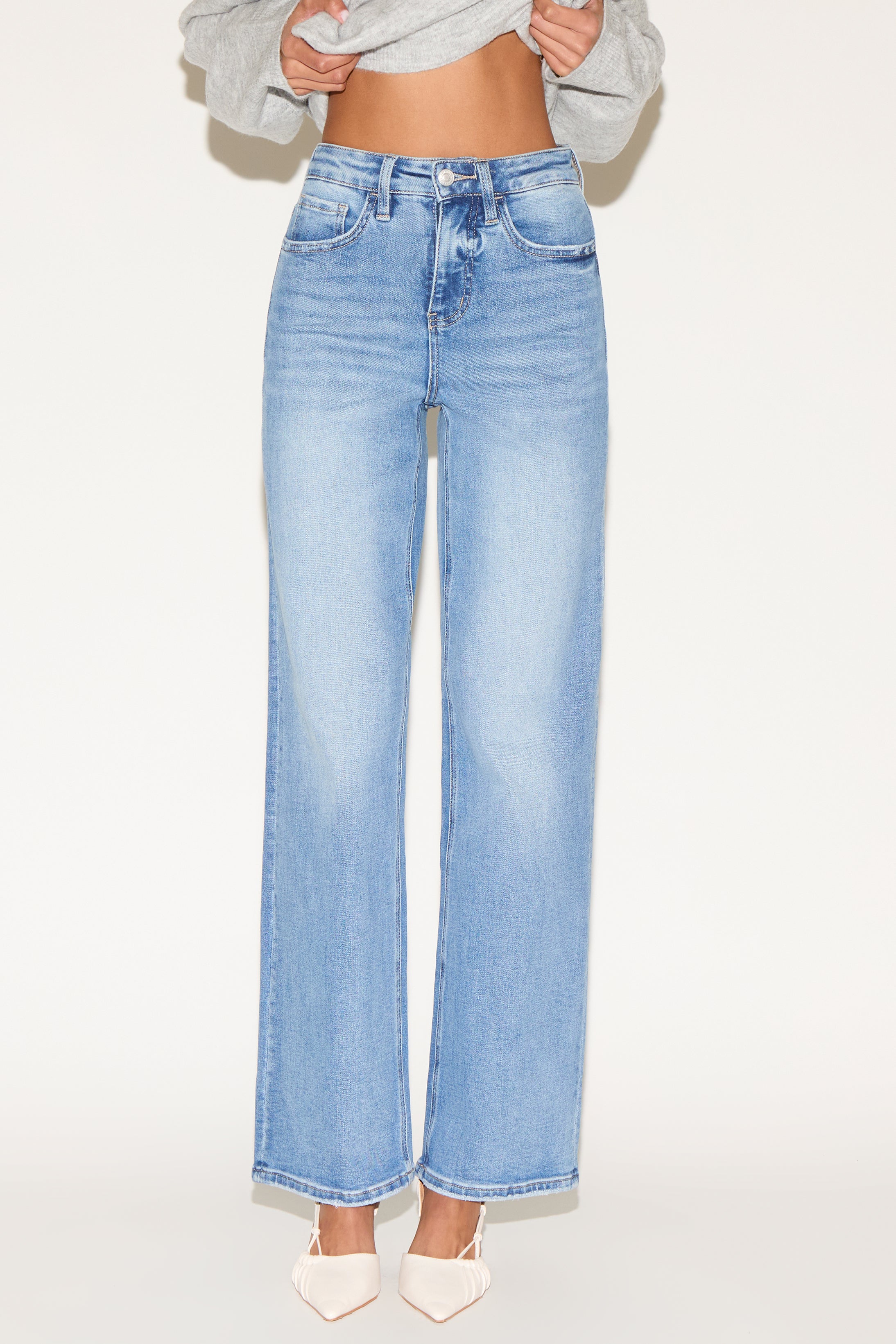 Front view of model wearing light wash denim.