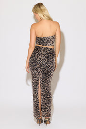 Model is wearing a leopard crop tube top and mesh maxi skirt set on a white background.