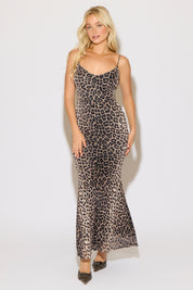 Model is wearing a leopard print v neck sleeveless mermaid maxi dress on a white background.
