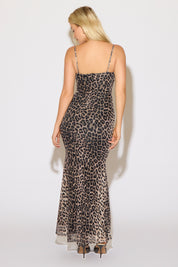 Model is wearing a leopard print v neck sleeveless mermaid maxi dress on a white background.
