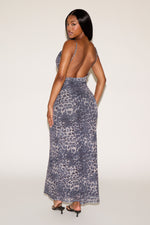 Woman wearing a leopard print dress on a white background