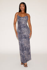 Woman wearing a patterned strapless dress on a white background