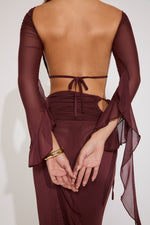 Maroon long-sleeve dress with cut-out design on a white background