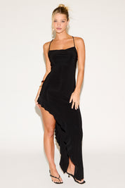 Woman wearing a black dress with a white background