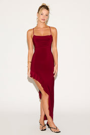 Woman wearing a burgundy dress with a white background