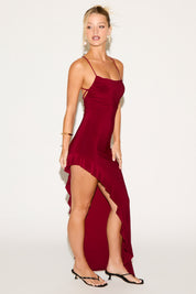 Woman wearing a red dress with a white background