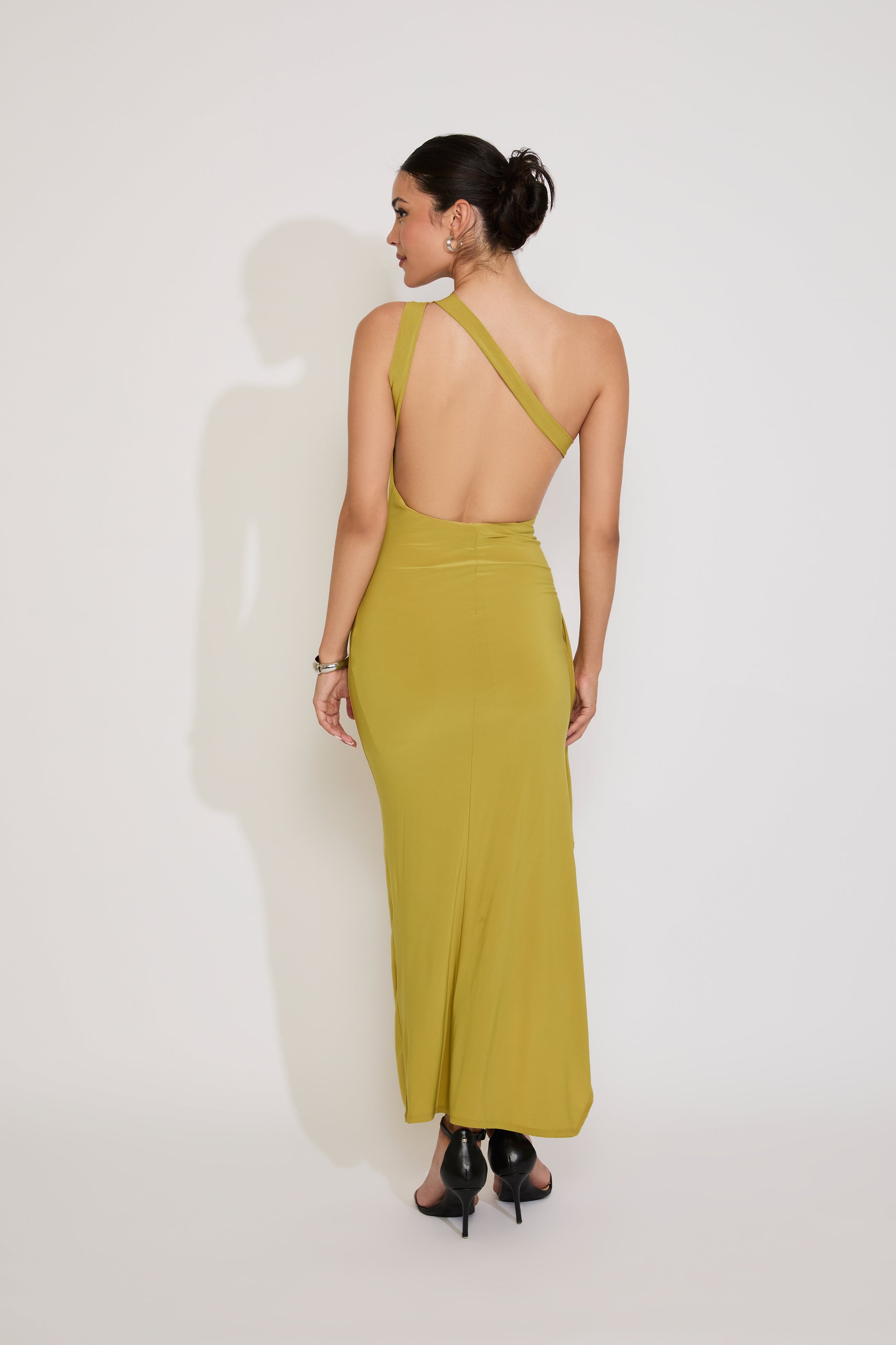 Woman wearing a green dress with a white background
