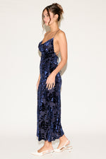 Woman wearing a blue floral dress on a white background